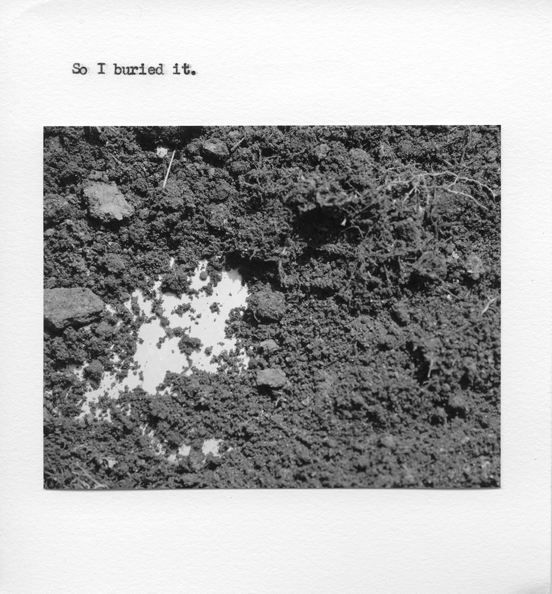 A photo a smooth surfacing peeking out beneath dirt. The text reads: “So I buried it.”